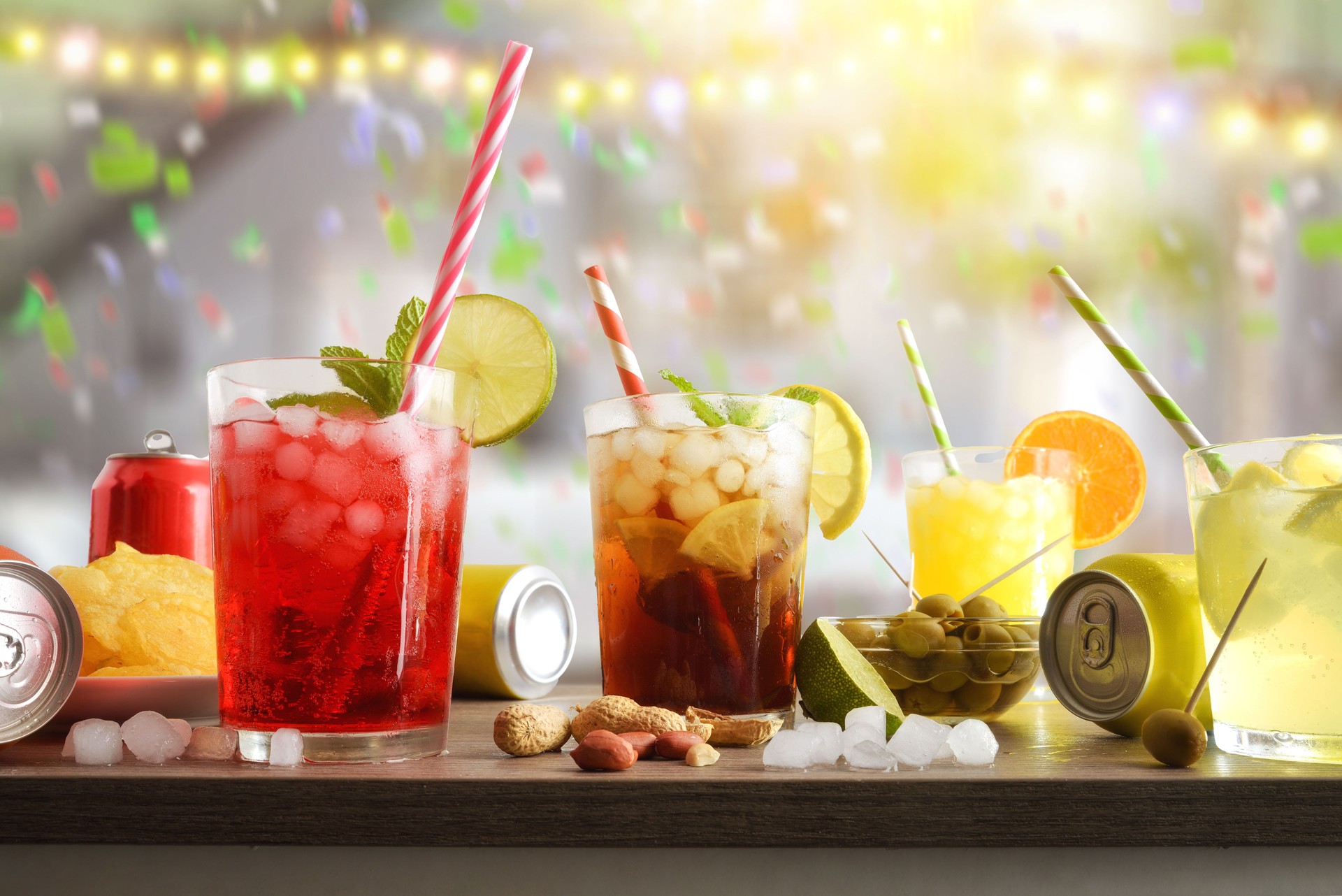Table with refreshing drinks and snacks with festive room background